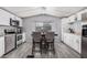 Bright kitchen with white cabinets, stainless steel appliances, and gray wood-look floors at 8107 E Butte St, Mesa, AZ 85207