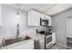 Updated kitchen featuring white cabinets, stainless steel appliances, and neutral countertops at 8107 E Butte St, Mesa, AZ 85207