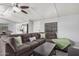 Comfortable living room featuring a large sectional sofa and modern ceiling fan at 8107 E Butte St, Mesa, AZ 85207