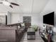Cozy living room with a large sectional, modern television, and neutral color scheme at 8107 E Butte St, Mesa, AZ 85207