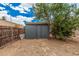 This backyard features a shed with a wood fence and mature trees at 8107 E Butte St, Mesa, AZ 85207