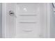 Clean and bright shower stall featuring built-in shelving for convenient storage at 8107 E Butte St, Mesa, AZ 85207