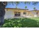 Backyard view with covered patio, grass, and plastic chairs at 8261 E Keats Ave # 396, Mesa, AZ 85209