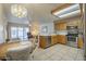 Well-lit kitchen featuring stainless steel appliances, wooden cabinetry, and a cozy dining area at 8261 E Keats Ave # 396, Mesa, AZ 85209