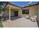 Backyard view with covered patio, grass, plastic chairs, and palm trees at 8261 E Keats Ave # 396, Mesa, AZ 85209