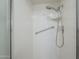 Modern shower with white tile, adjustable shower head, and built-in shelving at 8261 E Keats Ave # 396, Mesa, AZ 85209