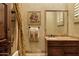 Bathroom with a marble vanity top, dark wooden cabinets and a shower with glass enclosure at 9290 E Thompson Peak Pkwy # 409, Scottsdale, AZ 85255