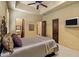 Comfortable bedroom with decorative bed frame, and cozy neutral toned decor throughout the space at 9290 E Thompson Peak Pkwy # 409, Scottsdale, AZ 85255