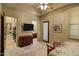 Comfortable bedroom featuring a ceiling fan, and access to the bathroom and outdoor area at 9290 E Thompson Peak Pkwy # 409, Scottsdale, AZ 85255
