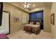 Comfortable bedroom with large window, blue accent wall, and decorative bed frame at 9290 E Thompson Peak Pkwy # 409, Scottsdale, AZ 85255