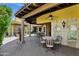 Spacious covered patio with ceiling fan, stone columns, and outdoor furniture at 9290 E Thompson Peak Pkwy # 409, Scottsdale, AZ 85255