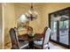 Elegant dining room with a unique chandelier, stylish chairs, and a decorative niche with a mural at 9290 E Thompson Peak Pkwy # 409, Scottsdale, AZ 85255