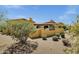 Desert home featuring a wall, tile roof and mature desert landscaping at 9290 E Thompson Peak Pkwy # 409, Scottsdale, AZ 85255