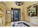 Elegant foyer featuring marble flooring, a decorative floral display, and intricate ironwork on the front door at 9290 E Thompson Peak Pkwy # 409, Scottsdale, AZ 85255