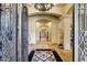Grand foyer with marble floors, ornate chandelier, and a view into the home's elegant interior at 9290 E Thompson Peak Pkwy # 409, Scottsdale, AZ 85255