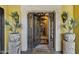 Elegant wrought iron front door flanked by potted plants, creating a grand entrance at 9290 E Thompson Peak Pkwy # 409, Scottsdale, AZ 85255