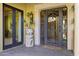 Inviting front entrance featuring a wrought iron door, stone accents, and a 'Welcome' mat at 9290 E Thompson Peak Pkwy # 409, Scottsdale, AZ 85255