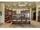 Gourmet kitchen featuring custom cabinets, granite counters, and a large center island with seating at 9290 E Thompson Peak Pkwy # 409, Scottsdale, AZ 85255