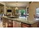 Kitchen island with sink, faucet, and stainless-steel dishwasher in a tan colored open floor plan at 9290 E Thompson Peak Pkwy # 409, Scottsdale, AZ 85255