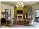 Living room with decorative fireplace, chandelier, and access to a patio at 9290 E Thompson Peak Pkwy # 409, Scottsdale, AZ 85255
