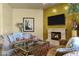 Living room with decorative fireplace and TV at 9290 E Thompson Peak Pkwy # 409, Scottsdale, AZ 85255