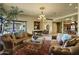 Tan living room with ornate couches and chandelier plus views to a patio and dining room at 9290 E Thompson Peak Pkwy # 409, Scottsdale, AZ 85255