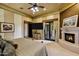 Tranquil main bedroom featuring a fireplace, ceiling fan, and balcony access, perfect for unwinding at 9290 E Thompson Peak Pkwy # 409, Scottsdale, AZ 85255