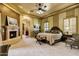 Inviting main bedroom with a cozy fireplace, ceiling fan, and a luxurious bed for ultimate relaxation at 9290 E Thompson Peak Pkwy # 409, Scottsdale, AZ 85255