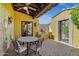 Covered patio featuring stone floors, comfortable seating, and a built-in outdoor kitchen and BBQ at 9290 E Thompson Peak Pkwy # 409, Scottsdale, AZ 85255