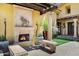 Covered patio featuring a stone fireplace, column supports, and comfortable stone benches for lounging at 9290 E Thompson Peak Pkwy # 409, Scottsdale, AZ 85255