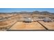 Expansive aerial view of a single-Gathering home on a large lot with block fencing in a desert landscape with mountain views at 9485 W Sandstone Mountain Dr, Casa Grande, AZ 85194