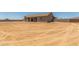 Tan single-story home with a large, unfinished backyard at 9485 W Sandstone Mountain Dr, Casa Grande, AZ 85194