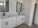 Modern bathroom with double vanity, quartz countertops, and dark hardware at 9485 W Sandstone Mountain Dr, Casa Grande, AZ 85194