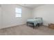 Carpeted bedroom with a window and a metal daybed with a light blue cover at 9485 W Sandstone Mountain Dr, Casa Grande, AZ 85194