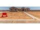 Exterior of a one-story tan home with a sidewalk leading to the front door, new construction at 9485 W Sandstone Mountain Dr, Casa Grande, AZ 85194