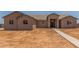 Tan single story house with tile roof and covered front porch, new construction at 9485 W Sandstone Mountain Dr, Casa Grande, AZ 85194