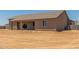 Rear exterior of a tan single-story home with a covered patio at 9485 W Sandstone Mountain Dr, Casa Grande, AZ 85194