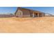 Newly constructed home featuring a covered patio and fenced yard in a peaceful neighborhood at 9485 W Sandstone Mountain Dr, Casa Grande, AZ 85194