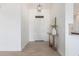 Entryway to home with decorative table and light fixture above at 9485 W Sandstone Mountain Dr, Casa Grande, AZ 85194