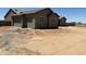 Spacious three-car garage with paneled doors on a home that needs landscaping at 9485 W Sandstone Mountain Dr, Casa Grande, AZ 85194