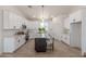 Modern kitchen with white cabinets, dark island, and stainless steel appliances at 9485 W Sandstone Mountain Dr, Casa Grande, AZ 85194