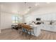 Bright kitchen with white cabinets, island with seating, and stainless steel appliances at 9485 W Sandstone Mountain Dr, Casa Grande, AZ 85194