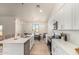 Kitchen features white cabinetry, stainless appliances, quartz countertops, and island with barstool seating at 9485 W Sandstone Mountain Dr, Casa Grande, AZ 85194