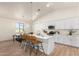 Bright kitchen with white cabinets, island with seating, and stainless steel appliances at 9485 W Sandstone Mountain Dr, Casa Grande, AZ 85194