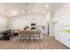 Bright kitchen with white cabinetry, an island with seating, and an adjoining dining area at 9485 W Sandstone Mountain Dr, Casa Grande, AZ 85194