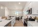 Open-concept kitchen featuring white cabinets, stainless appliances, quartz countertops, and a large center island at 9485 W Sandstone Mountain Dr, Casa Grande, AZ 85194