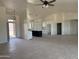 Open-concept living room and kitchen feature vaulted ceilings, stylish lighting, and neutral finishes throughout at 9485 W Sandstone Mountain Dr, Casa Grande, AZ 85194