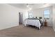 Bright main bedroom features neutral carpet, a ceiling fan, and light colored walls at 9485 W Sandstone Mountain Dr, Casa Grande, AZ 85194
