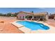 Backyard pool area is ideal for outdoor entertaining, complemented by patio seating and mature landscaping at 9566 E Plana Ave, Mesa, AZ 85212