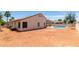 Expansive backyard with a pool, covered patio, and desert landscaping offers a private and relaxing outdoor space at 9566 E Plana Ave, Mesa, AZ 85212